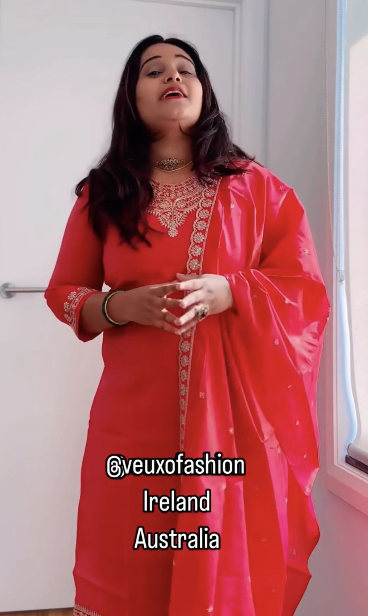  Vibrant Coral Suit with Intricate Gold Embroidery