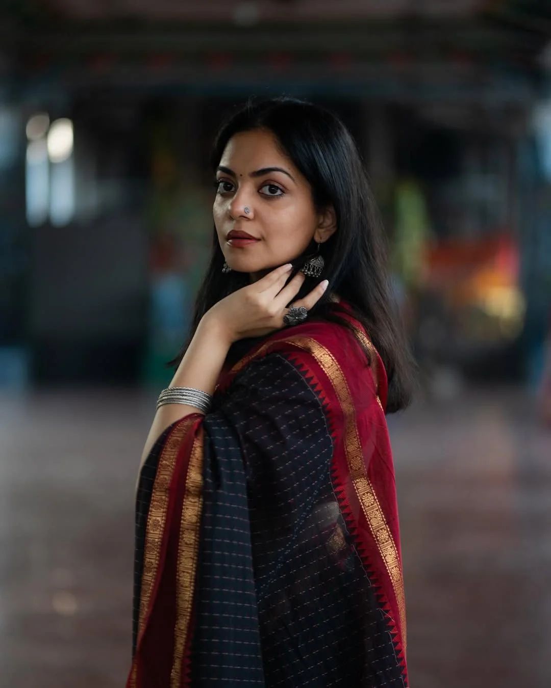 Black Saree with a subtle checked pattern and a broad Maroon and Gold Striped Border with Blouse