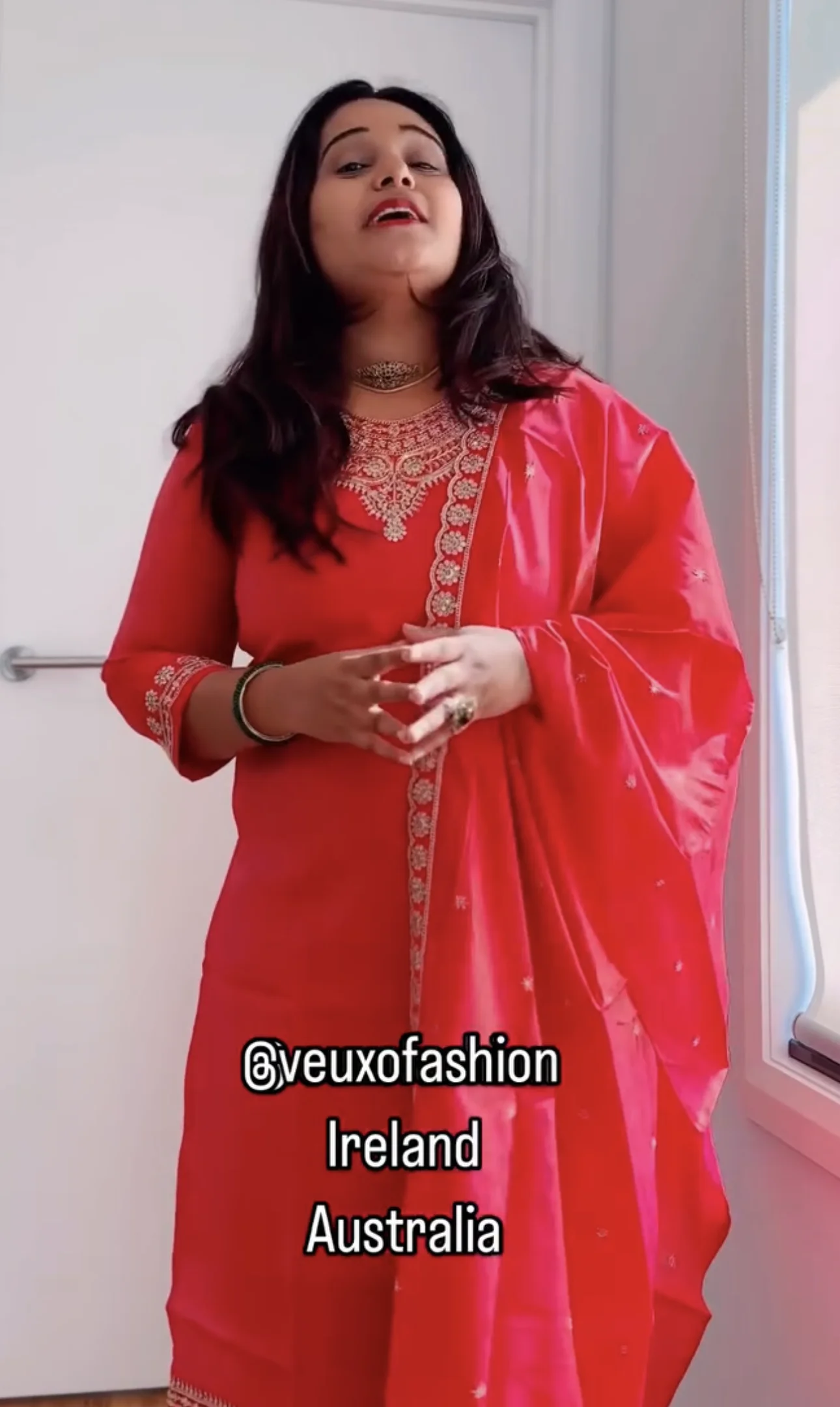  Vibrant Coral Suit with Intricate Gold Embroidery