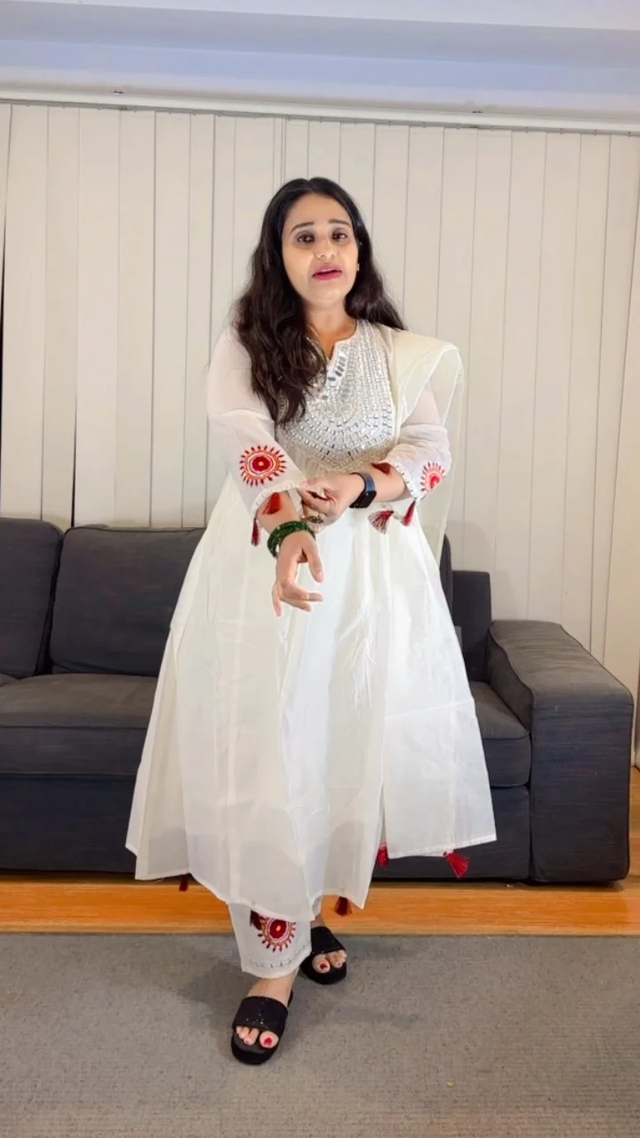 White Anarkali Salwar Suit with Mirror Work Yoke and Red Tassels - Image 2