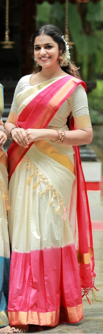 White and Gold Kasavu Saree with Pink and Red Border, and Tassels.