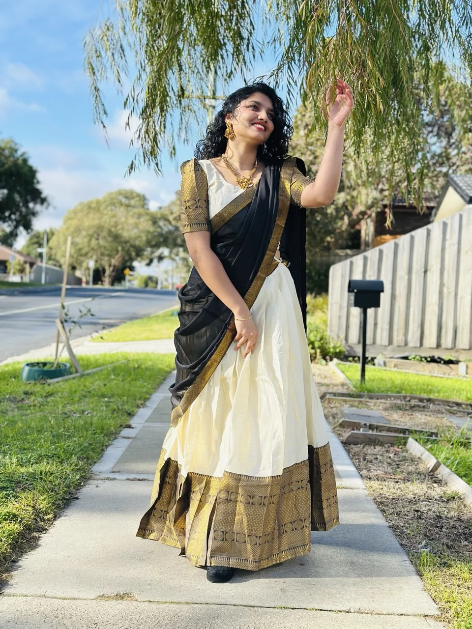 White and Gold Lichi Silk Dhavani Set with Black Dupatta and Gold Brocade Details.