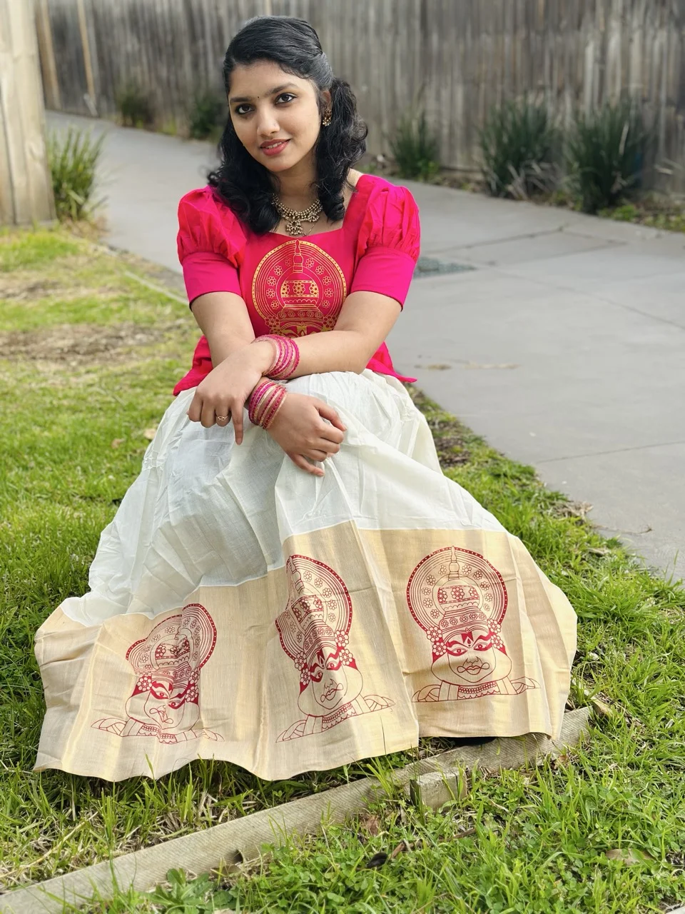 Pink Top with Gold Circular Print and White Dhavani Skirt with a Kathakali-Motif Border