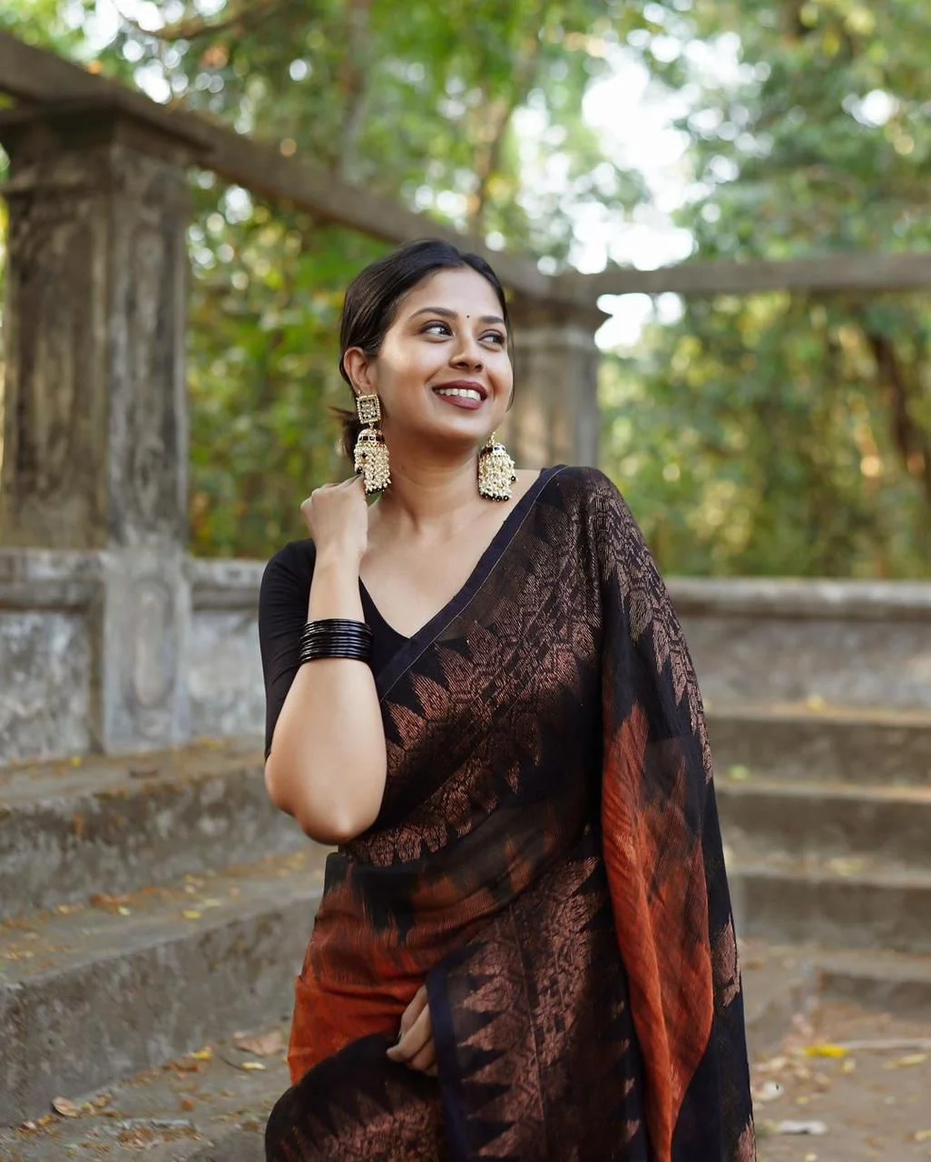 Black and copper-toned saree with floral and geometric motifs