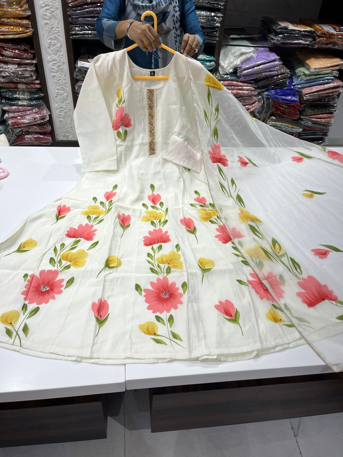 White Anarkali Suit with Hand-Painted Pink and Yellow Floral Motifs and a matching Sheer Floral Dupatta