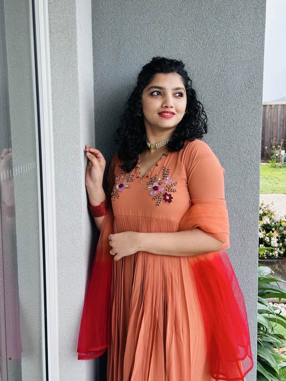 ALAINA - Rust Orange Anarkali Kurta with Multicolor Floral Embroidery on the yoke, paired with a Orange Red Dupatta